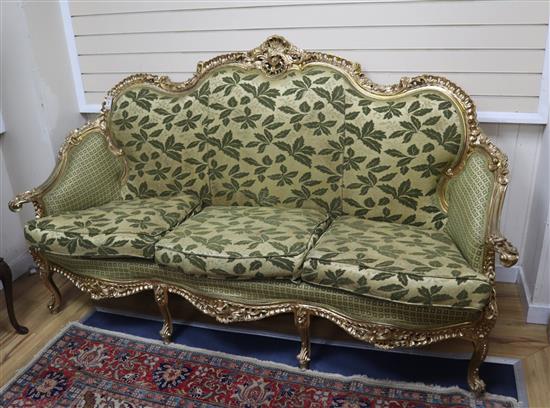 A Louis XVI style giltwood three seater carved settee W.206cm